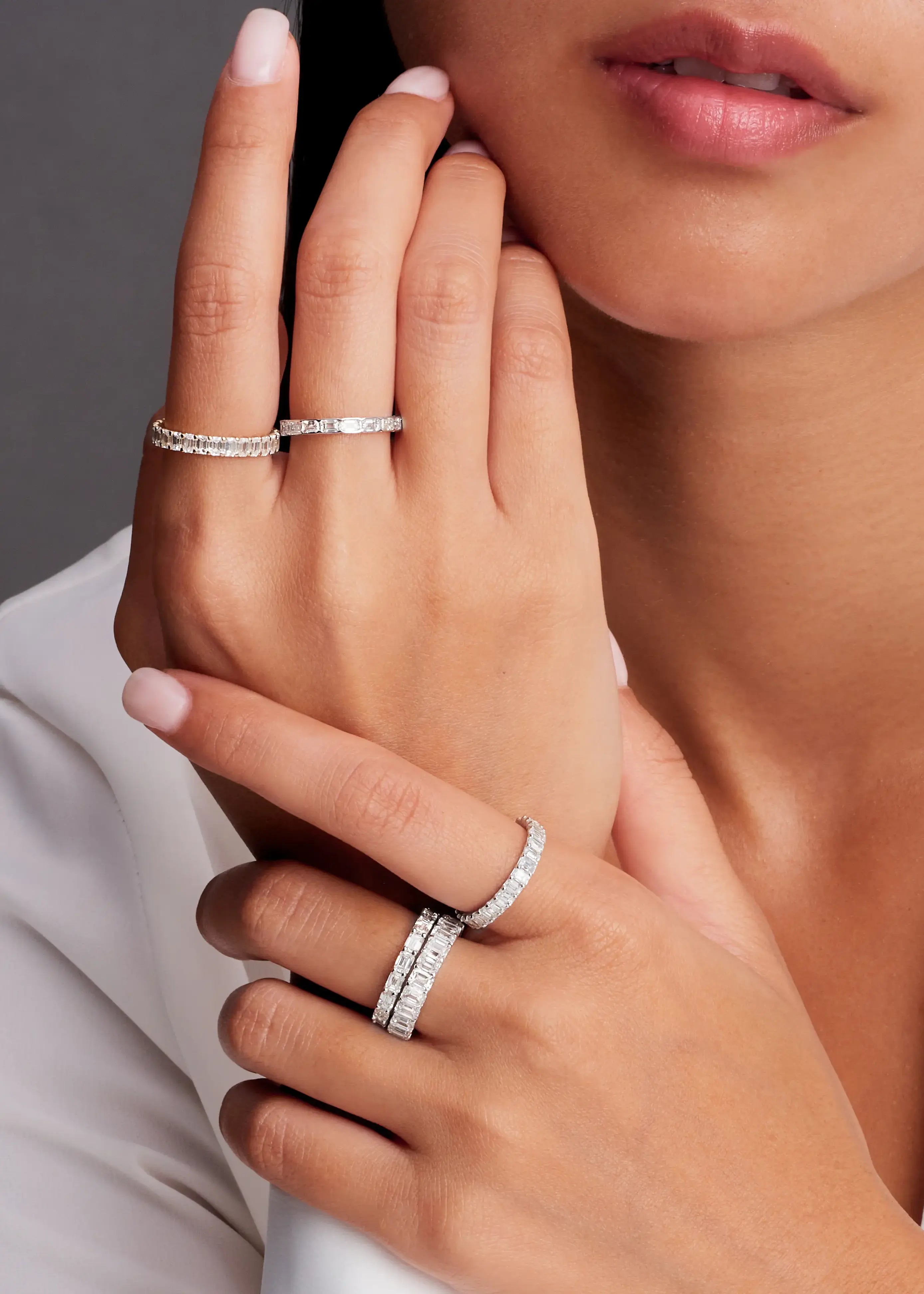 women with 14k white gold rings and natural emerald cut diamonds