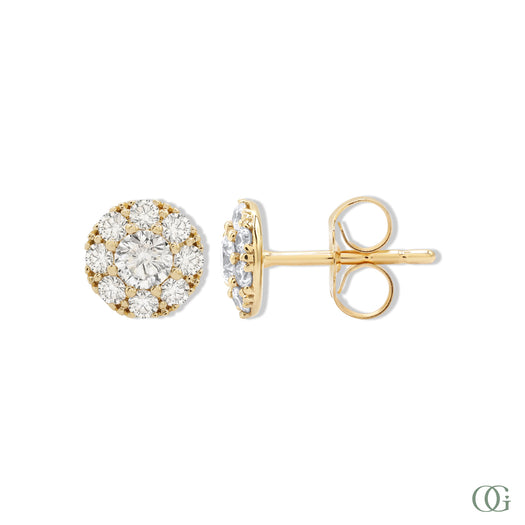 A pair of sparkling round diamond earrings with a gold-tone band and white gold mounting.