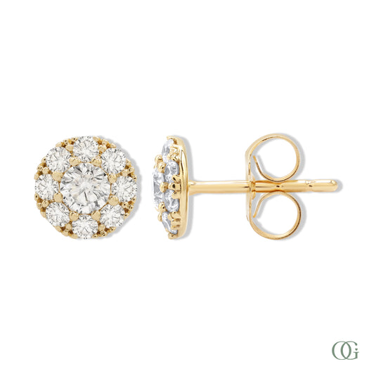 A pair of sparkling round diamond stud earrings with a gold band and smaller round diamonds around the main studs.