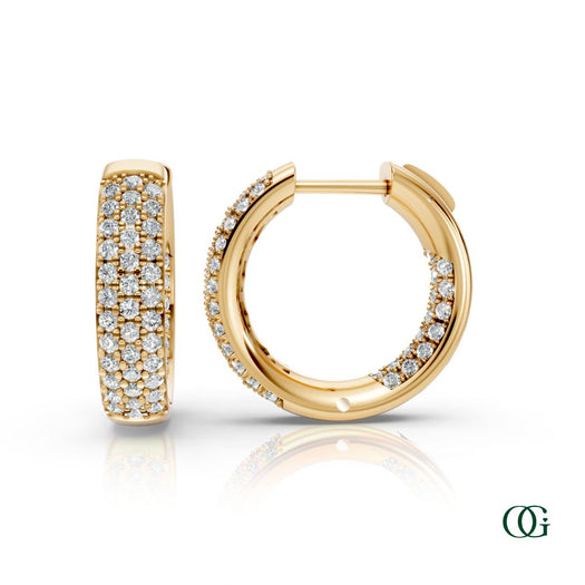 Y | A pair of yellow gold inside-out hoop earrings paved with round diamonds, displayed on a clean white background with a soft reflection below. 