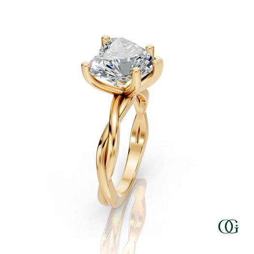 Y | A heart-shaped diamond engagement ring in a yellow gold setting with a twisted band, shown on a clean white background with a soft reflection.