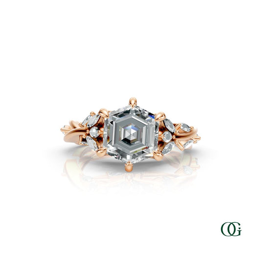 R | A Rose gold diamond ring featuring a central princess-cut diamond surrounded by smaller round and marquise-cut diamonds, set on a white background with a subtle reflection.