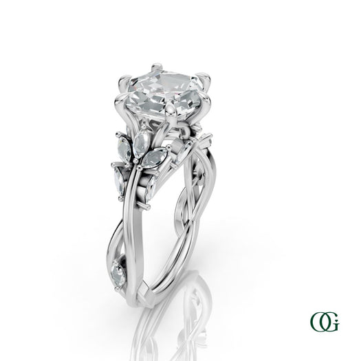 W | A white gold diamond ring featuring a central princess-cut diamond surrounded by smaller round and marquise-cut diamonds, set on a white background with a subtle reflection.