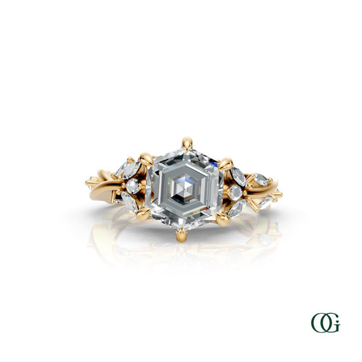 Y | A yellow gold diamond ring featuring a central princess-cut diamond surrounded by smaller round and marquise-cut diamonds, set on a white background with a subtle reflection.