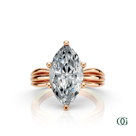 R | A rose gold ring featuring a large marquise-cut clear gemstone in a prong setting, with a sculptural, ribbed shank.