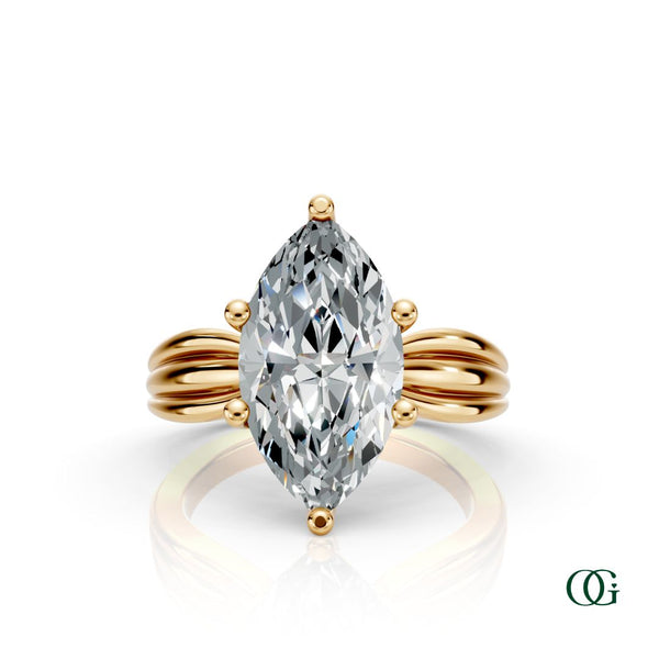 Y | A yellow gold ring featuring a large marquise-cut clear gemstone in a prong setting, with a sculptural, ribbed shank.