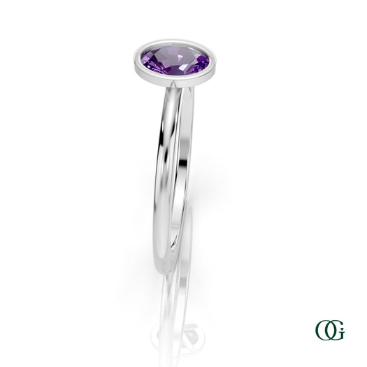 W| A white gold ring featuring an oval amethyst birthstone for February 