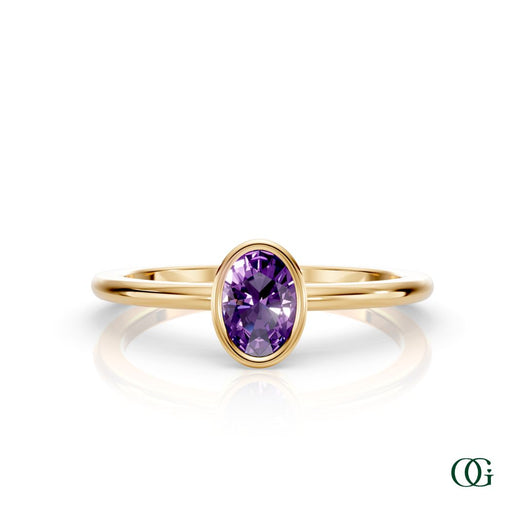Y| A yellow gold ring featuring an oval amethyst birthstone for February 