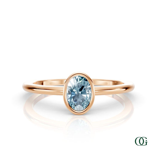 R| A rose gold ring featuring an oval aquamarine birthstone for March