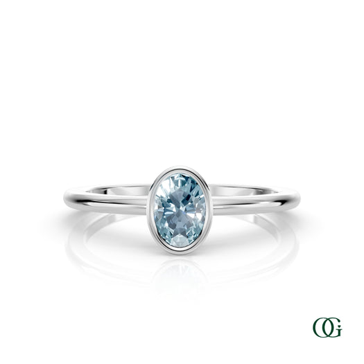 W| A white gold ring featuring an oval aquamarine birthstone for March