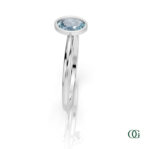 W| A white gold ring featuring an oval aquamarine birthstone for March