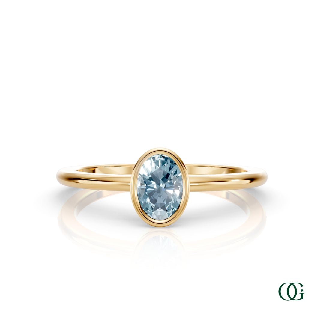 Y| A yellow gold ring featuring an oval aquamarine birthstone for March