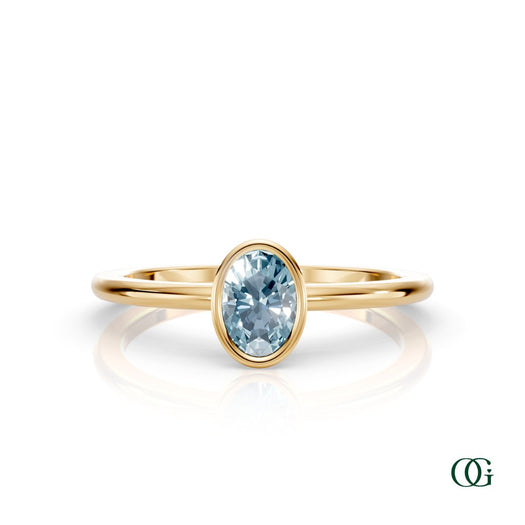 Y| A yellow gold ring featuring an oval aquamarine birthstone for March