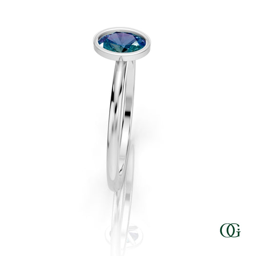 W| A white gold ring featuring an oval alexandrite birthstone for June