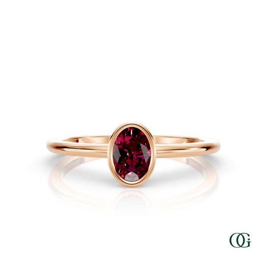 R| A rose gold ring featuring an oval garnet birthstone for January