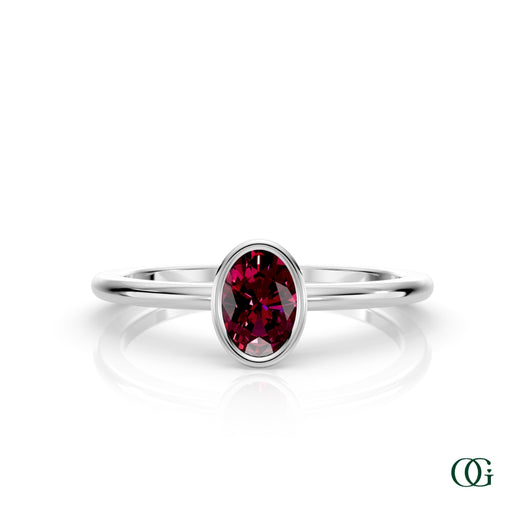 W| A white gold ring featuring an oval garnet birthstone for January