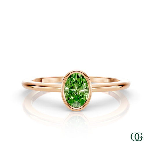 R| A rose gold ring featuring an oval peridot birthstone for August