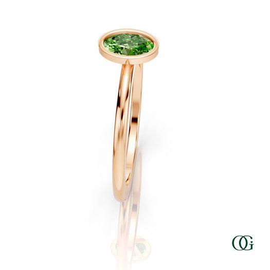 R| A rose gold ring featuring an oval peridot birthstone for August