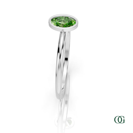 W| A white gold ring featuring an oval peridot birthstone for August