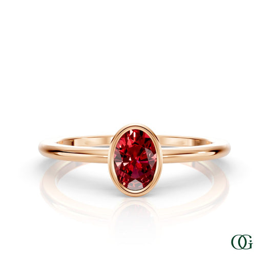 R| A rose gold ring featuring an oval ruby birthstone for July