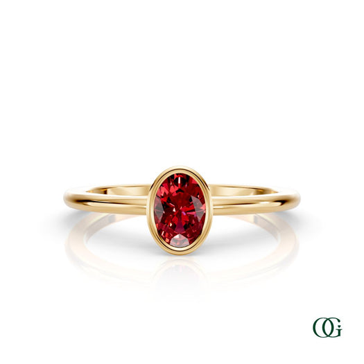 Y| A yellow gold ring featuring an oval ruby birthstone for July