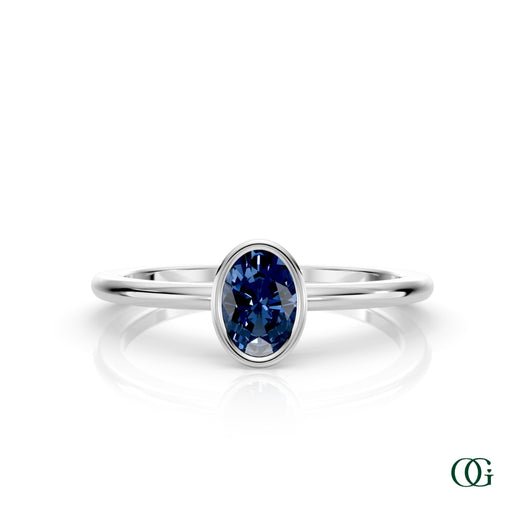 W| A white gold ring featuring an oval sapphire birthstone for September 