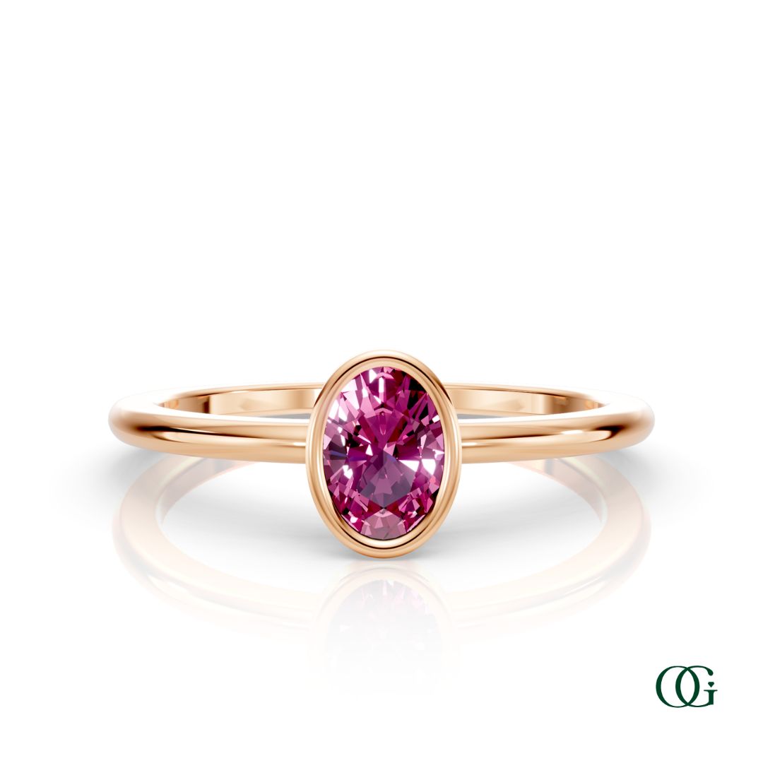 R| A rose gold ring featuring an oval tourmaline birthstone for October