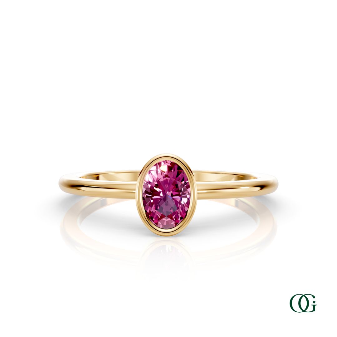 Y| A yellow gold ring featuring an oval tourmaline birthstone for October