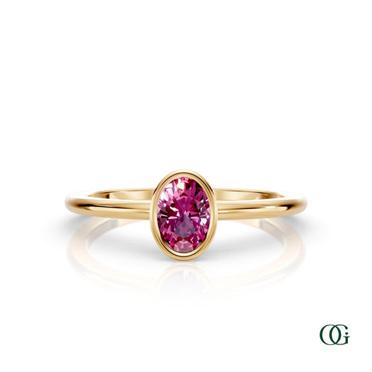 Y| A yellow gold ring featuring an oval tourmaline birthstone for October