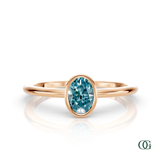 R| A rose gold ring featuring an oval topaz birthstone for December
