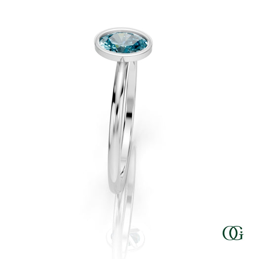 W| A white gold ring featuring an oval topaz birthstone for December