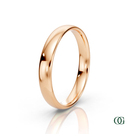 R | A polished rose gold wedding band ring standing upright on a white reflective surface.