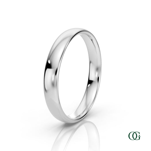 W | A polished white gold wedding band ring standing upright on a white reflective surface.