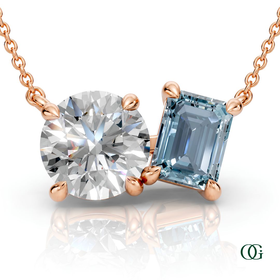 R | rose gold necklace with two stones: a round diamond center stone and an  emerald-cut aquamarine side stone.