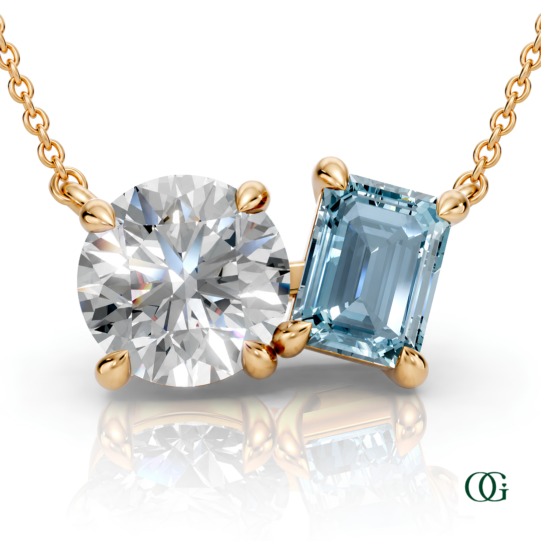 Y | gold necklace with two stones: a round diamond center stone and an  emerald-cut aquamarine side stone.