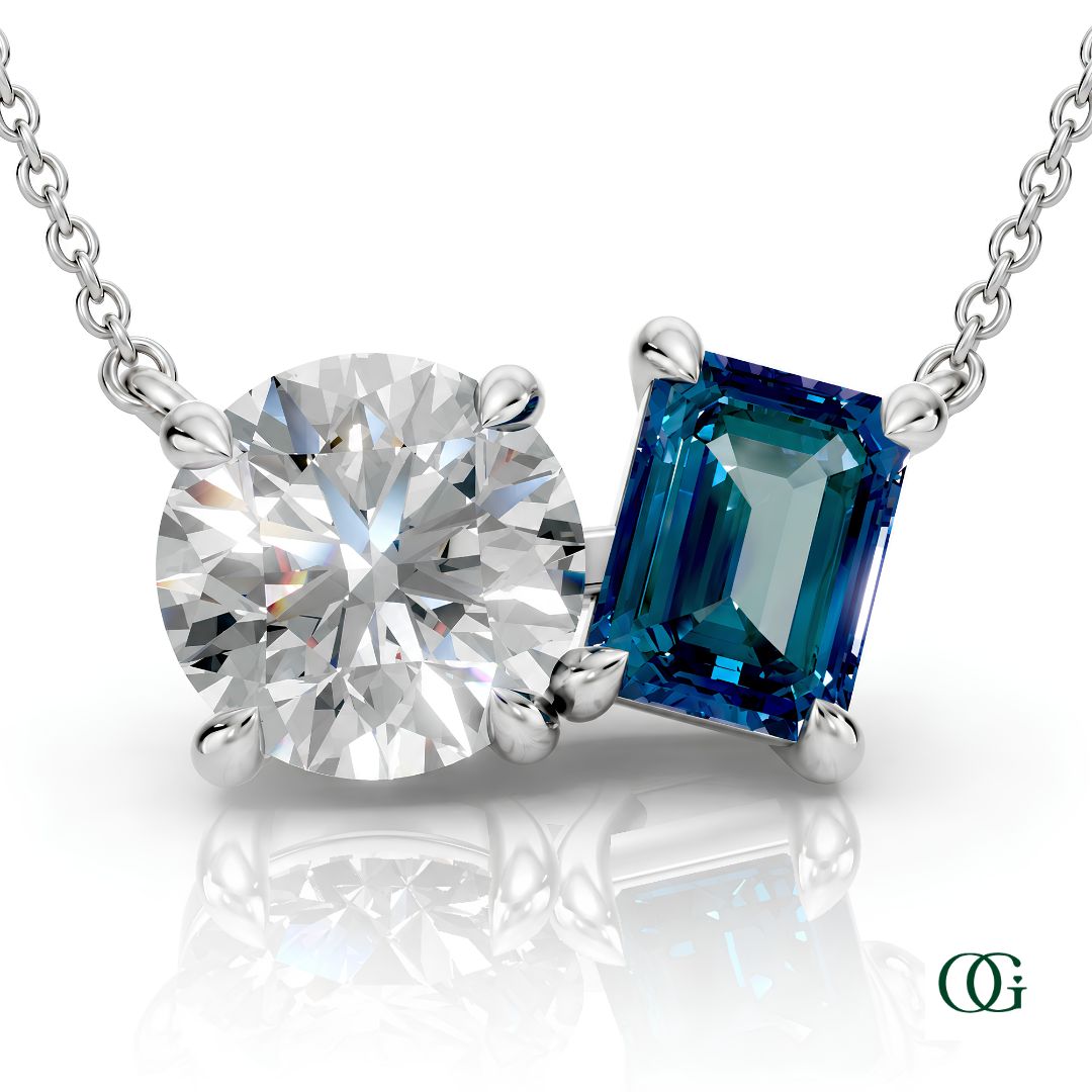W | white gold necklace with two stones: a round diamond center stone and an  emerald-cut alexandrite side stone.