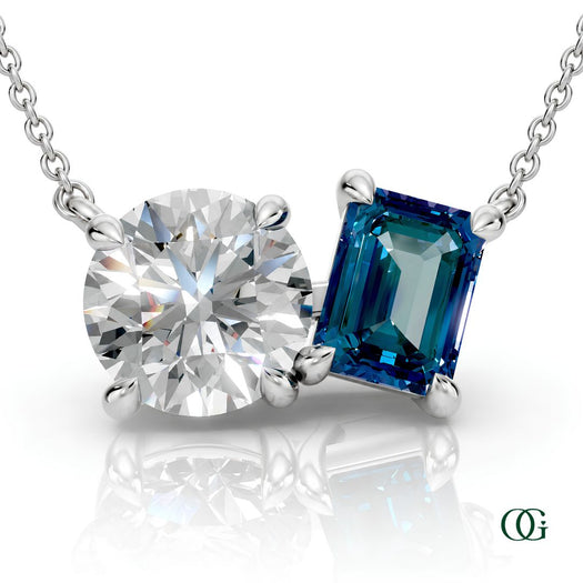 W | white gold necklace with two stones: a round diamond center stone and an  emerald-cut alexandrite side stone.