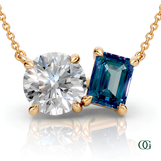 Y | gold necklace with two stones: a round diamond center stone and an  emerald-cut allexandrite side stone.