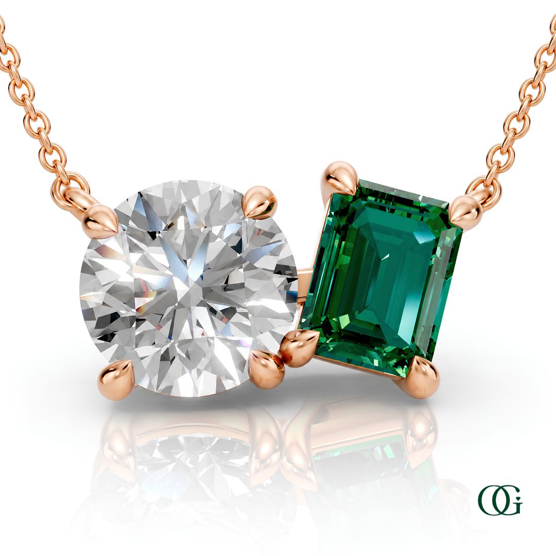 R | rose gold necklace with two stones: a round diamond center stone and an  emerald-cut emerald side stone.