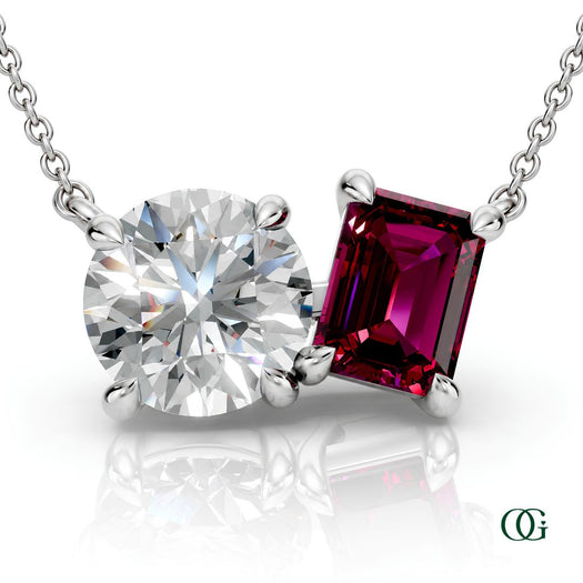W | white gold necklace with two stones: a round diamond center stone and an  emerald-cut garnet side stone.
