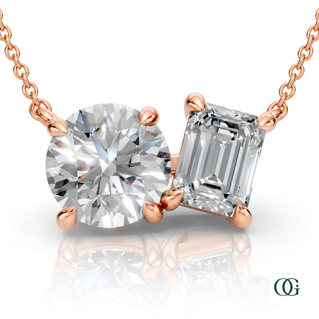 R | rose gold necklace with two stones: a round diamond center stone and an  emerald-cut diamond side stone.