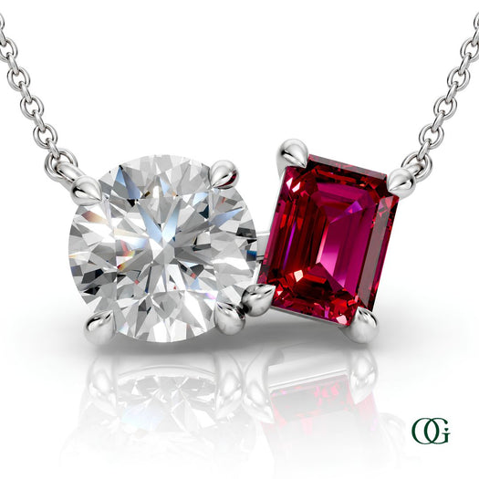 W | white gold necklace with two stones: a round diamond center stone and an  emerald-cut ruby side stone.