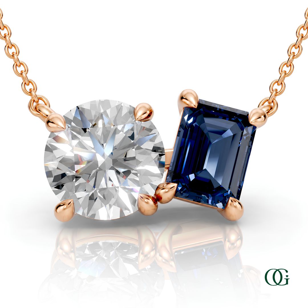 R | rose gold necklace with two stones: a round diamond center stone and an  emerald-cut sapphire side stone.