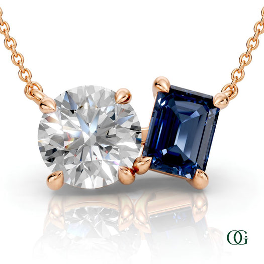 R | rose gold necklace with two stones: a round diamond center stone and an  emerald-cut sapphire side stone.