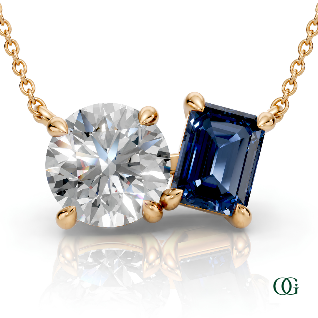 Y | gold necklace with two stones: a round diamond center stone and an  emerald-cut sapphire side stone.