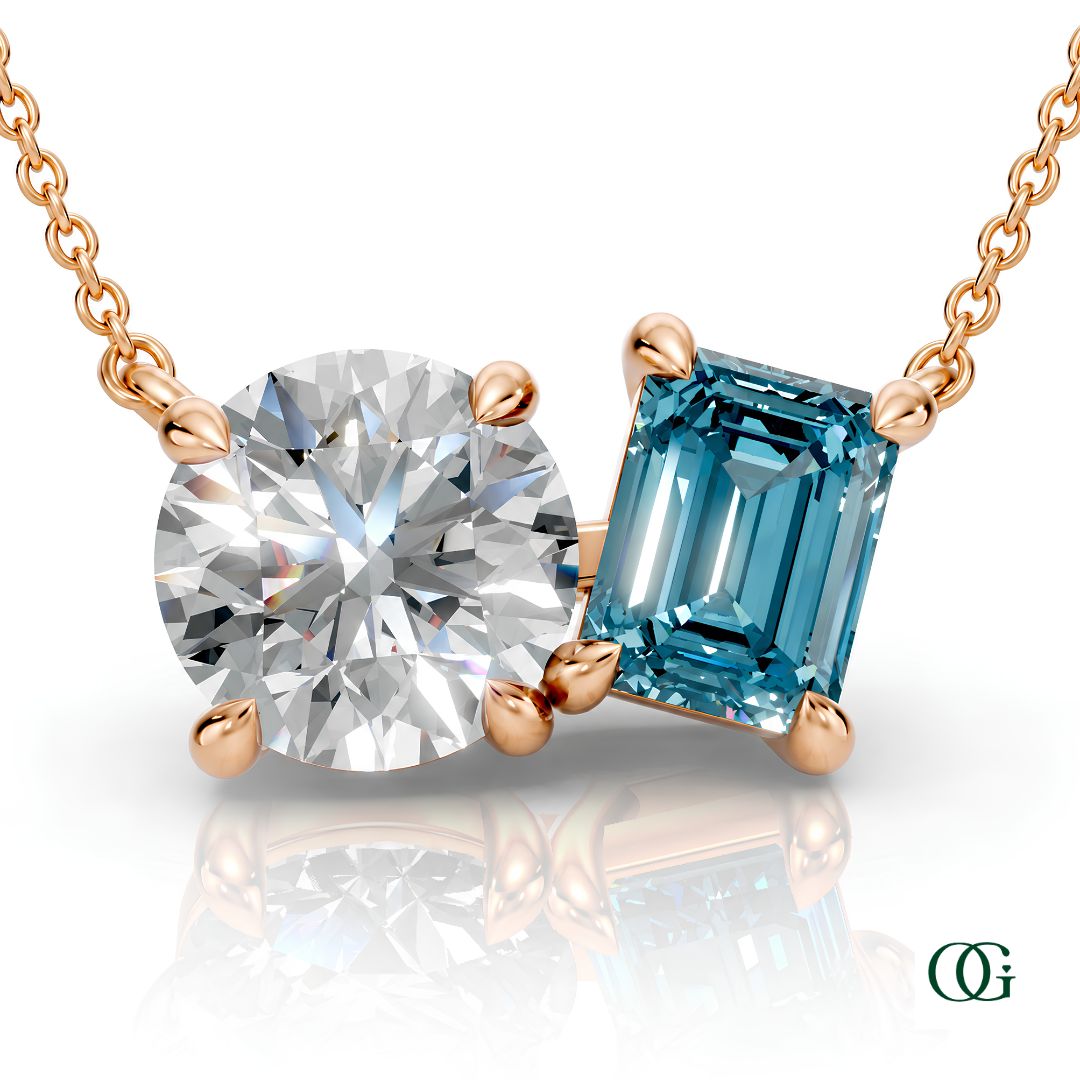 R | rose gold necklace with two stones: a round diamond center stone and an  emerald-cut topaz side stone.