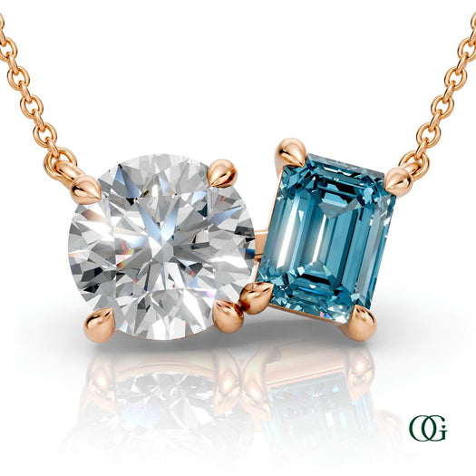 R | rose gold necklace with two stones: a round diamond center stone and an  emerald-cut topaz side stone.
