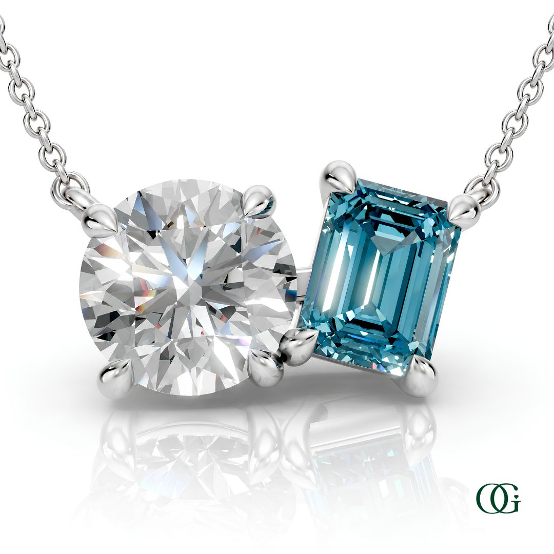 W | white gold necklace with two stones: a round diamond center stone and an  emerald-cut topaz side stone.