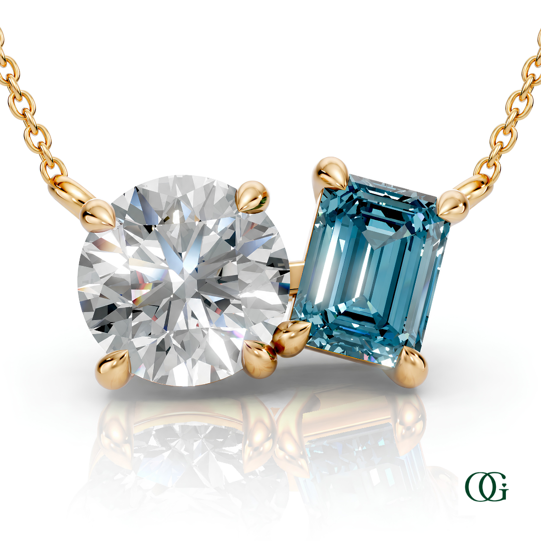 Y | gold necklace with two stones: a round diamond center stone and an  emerald-cut topaz side stone.