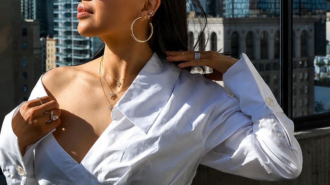 Woman wearing a white blouse with a city skyline in the background